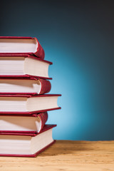 pile of  books on wooden table