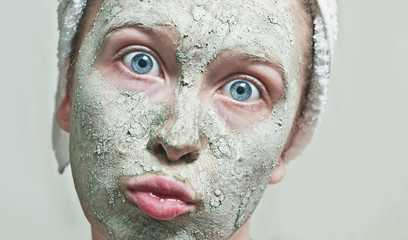 Headshot of young female with a duckface and a cosmetic mask