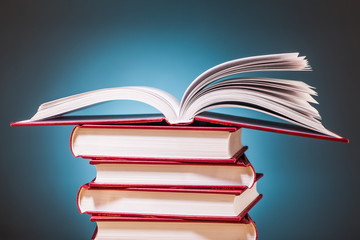 pile of books   on wooden table