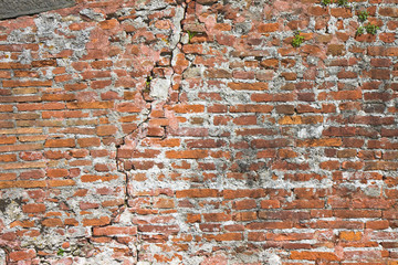 Brick wall deeply cracked - concept image