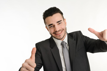 isolated business man in positive attitude with his thumbs up