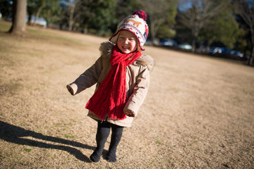 Fototapeta premium 冬の公園で遊ぶ少女