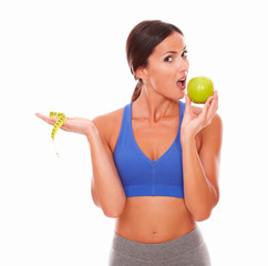 Sporty female eating apple to keep fit