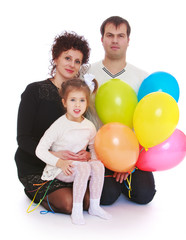 Fototapeta na wymiar Happy young family with balloons.