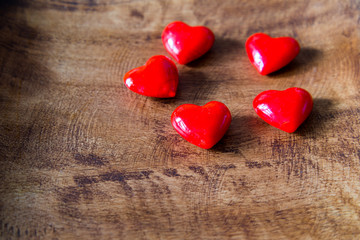 Valentines Day background with hearts on wooden background.