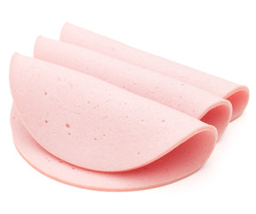 cooked boiled ham sausage or rolled bologna slices isolated on w © Natika