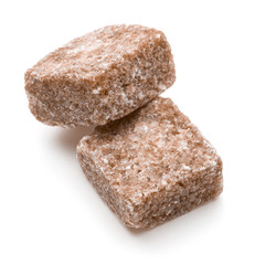 Brown lump cane sugar cube isolated on white background cutout