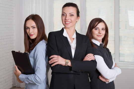 Three Girls In Formal Clothes Are Of Different Heights