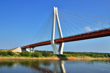 a big red and white bridge through the river