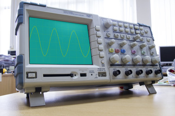 Oscilloscope with sine wave illustration