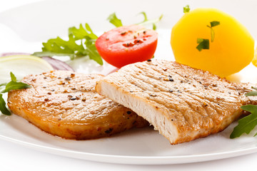 Fried steaks, boiled potatoes and vegetable salad