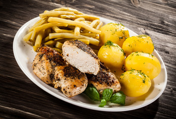 Fried chicken fillets, boiled potatoes and vegetable salad