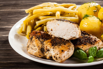 Fried chicken fillets, boiled potatoes and vegetable salad