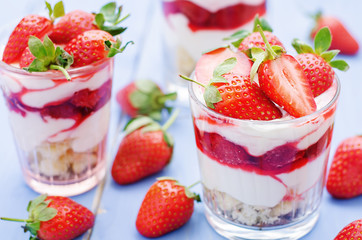 layered dessert with strawberries, biscuit cake and cream cheese