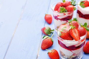 layered dessert with strawberries, biscuit cake and cream cheese