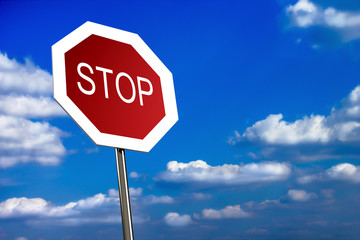 Stop sign on blue sky