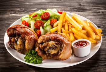 Grilled turkey legs with chips and vegetables