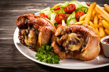 Grilled turkey legs with chips and vegetables