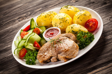 Fried steak, boiled potatoes and vegetable salad
