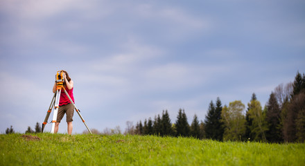 Young land surveyor at work.