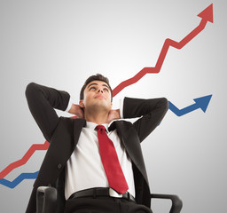 Businessman looking at a growing graph