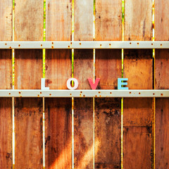 word love on a wooden door in fence