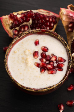Dish of banana millet breakfast pudding with pomegranate