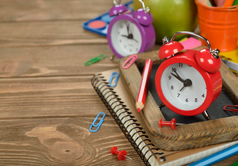 Red alarm clock and office supplies