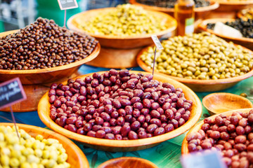 Different marinated olives on provencal street market in Provenc