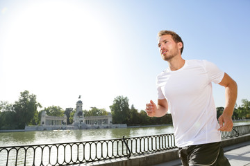 Jogging man running in city park El Retiro Madrid