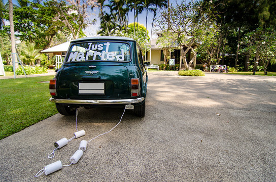 Rear view vintage car with just married sign, cans attached