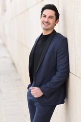 Attractive young businessman in urban background