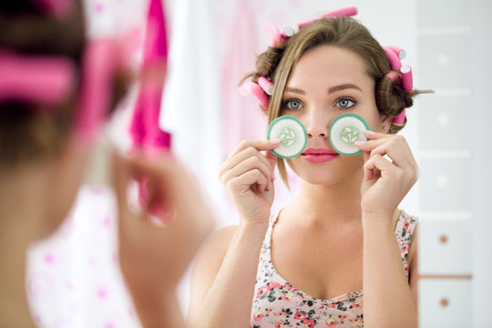 Young Girl Holding Slice Cucumber For Eyes Treatment