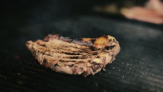 Steak on the barbecue with flames