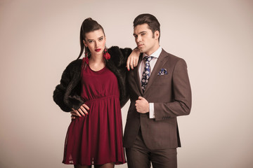 Fashion woman holding her arm on her lovers shoulder