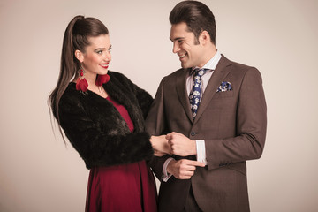 Happy young fashion couple laughing