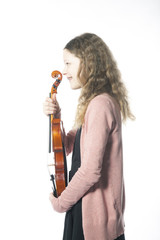young girl with braces stands in studio and holds violin