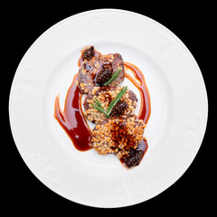 Venison fillet fried with pine nuts, isolated