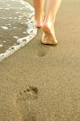 Girl leaves footprints in the sand