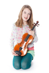 young girl sits in studio and holds violin