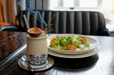 Appetizer and cocktail served with burning herbs