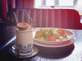 Appetizer and cocktail served with burning herbs, toned