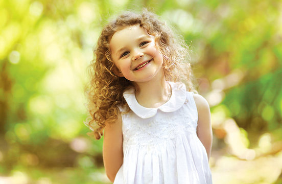 Cute child shone with happiness, curly hair, charming smile