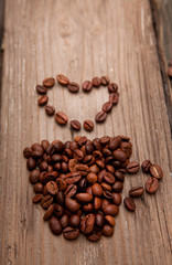 coffee beans and cup on wooden background
