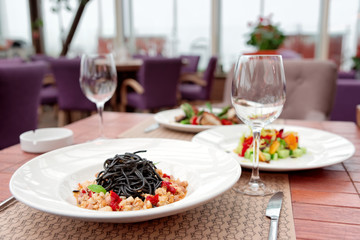 Black squid ink pasta with seafood and other dishes