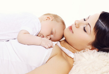 Mother with baby sleeping together at home
