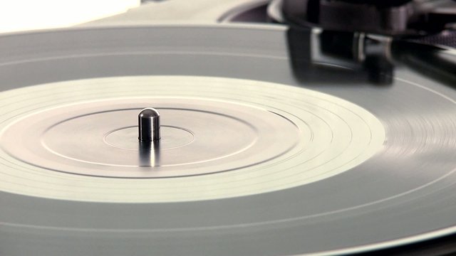 DJ Turntable. Close-up of a spinning vinyl, pan-shot