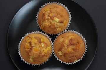 Muffins with orange zest just taken from the oven.
