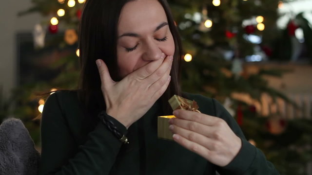Amazed woman looking at magical christmas gift in the box
