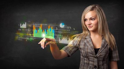 Young business woman touching colorful charts and diagrams